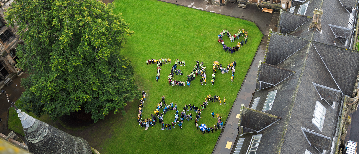 Aerial photo of students spelling out Team UofG
