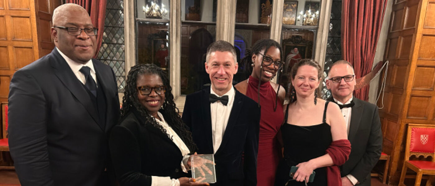 Professor Simon Anderson, Co-Director of the Glasgow Caribbean Centre for Development Research; Dr Peggy Brunache, Director of the Beniba Centre for Slavery Studies; Dr David Duncan, UofG's Chief Operating Officer & Deputy Vice Chancellor; Taylar Carty, James McCune PhD scholar; Dr Christine Whyte, Historian and Dr Stephen Mullen, Historian and co-author of the 2018 Slavery, Abolition & the University of Glasgow report are photographed with the UWI Chancellor's Award.