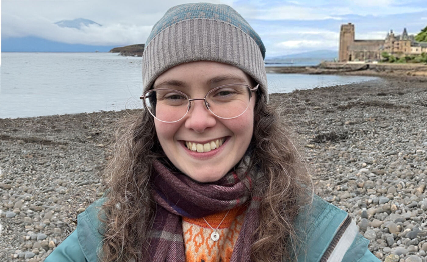 Dr Mona O'Brien, Effective Learning Adviser, standing on a sea shore for a photo