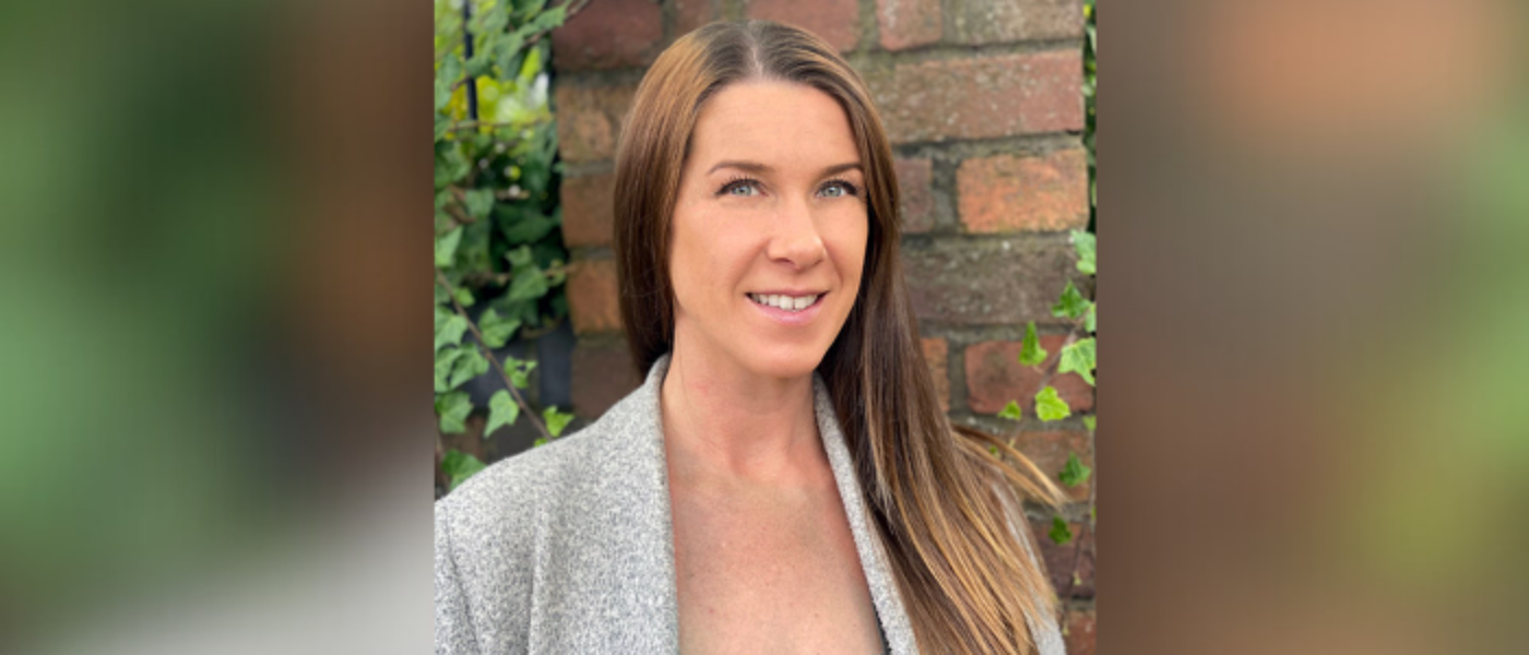 Dr Lindsay Balfour posing for a professional headshot, looking at camera