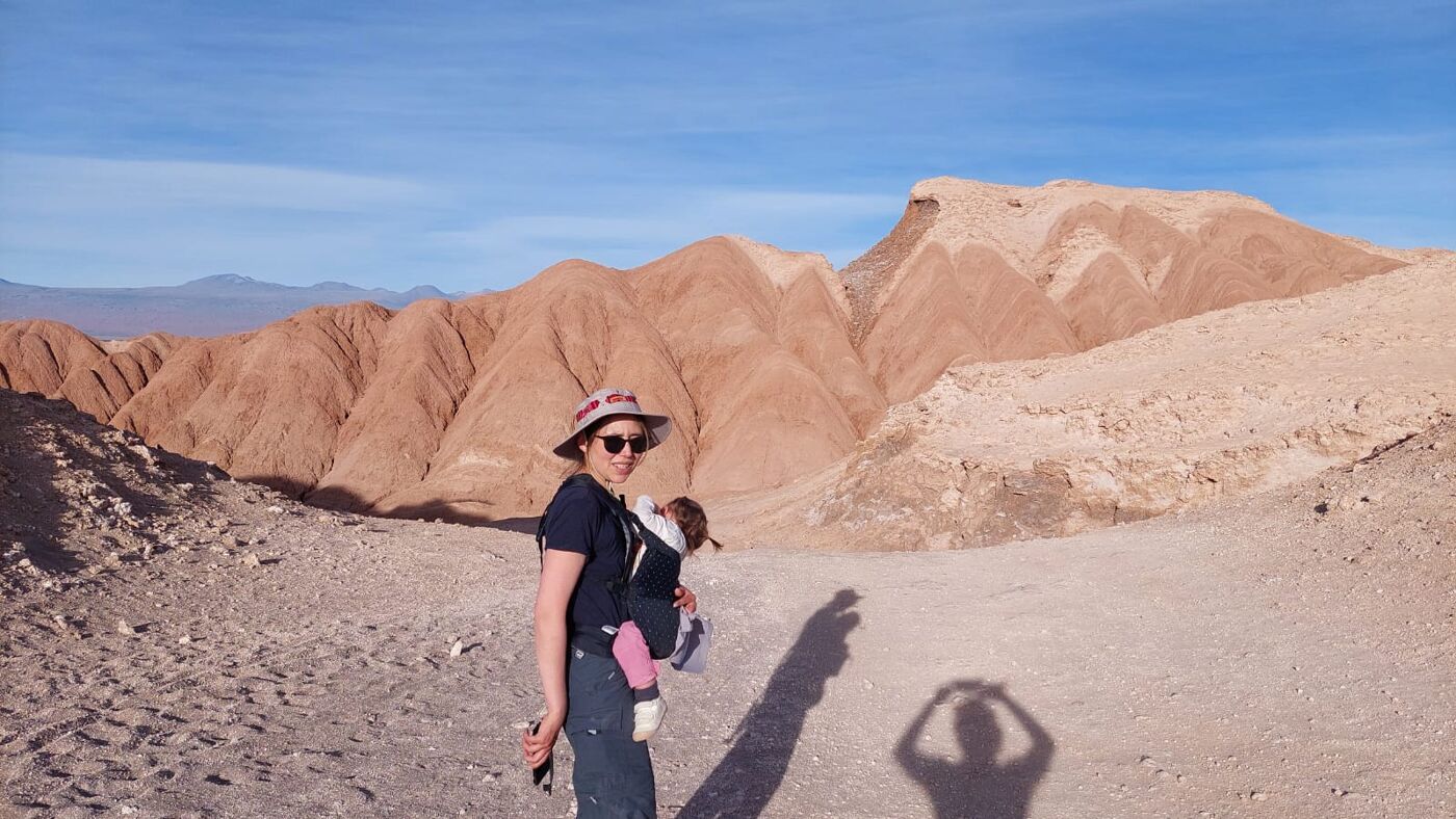 Woman with baby, walking in the desert