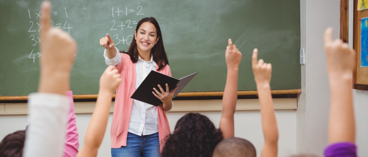 Maths primary teacher, students with their hands up
