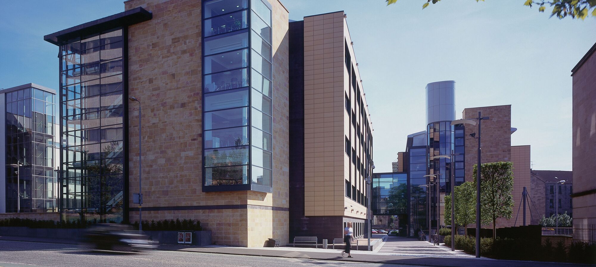 The Sir Graeme Davies Building and BHF Glasgow Cardiovascular Research Centre taken on a sunny day from across University Avenue