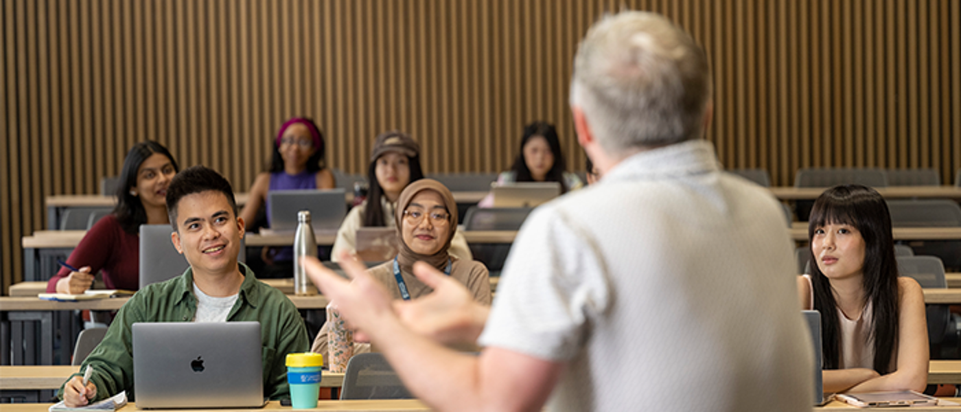 Group of students in lecture theatre facing lecturer