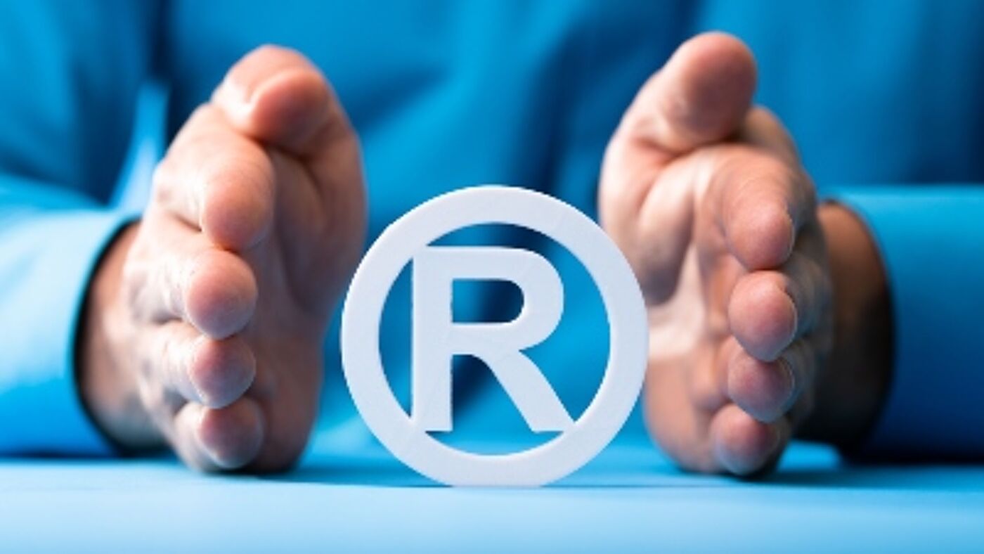 Hands framing a symbol of registered