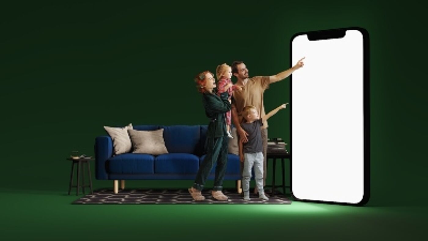 A family looking at the giant smartphone screen
