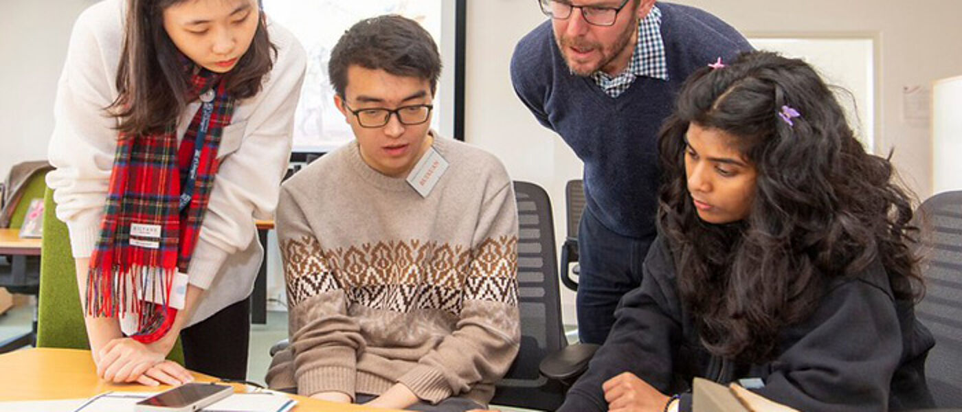 3 students in a small study group with their lecturer
