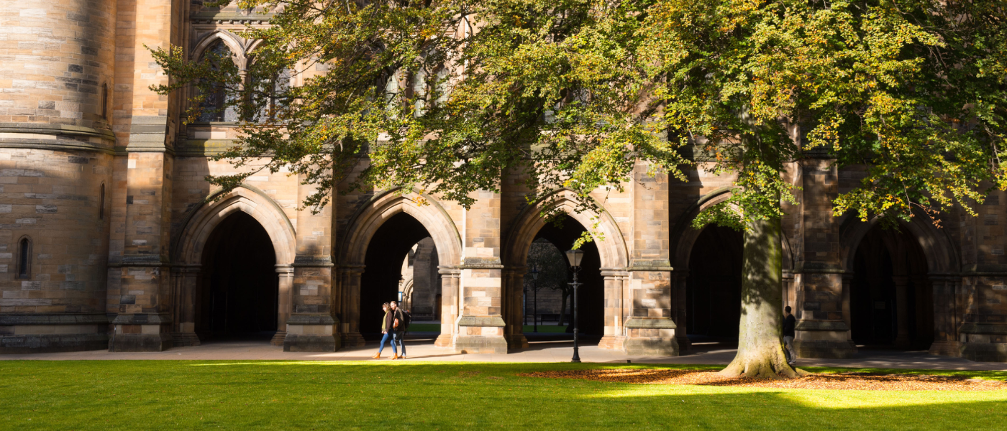 students walking in the east quad next to the cloisters