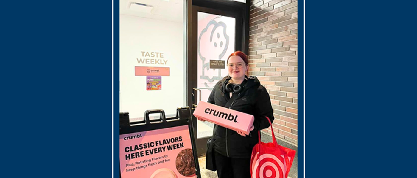 A female young student holding a cafe sign