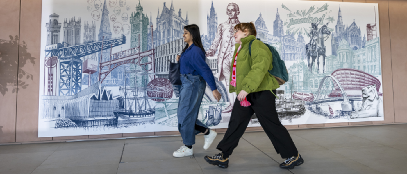 Students walking in front of mural in the Interior of the Adam Smith Building.