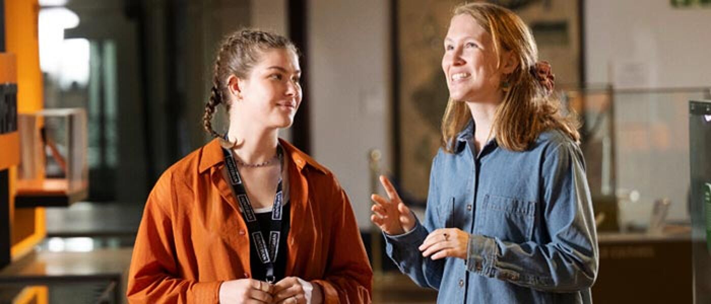 A student volunteer taking part in training with a member of staff in the University's Huntarian Museum