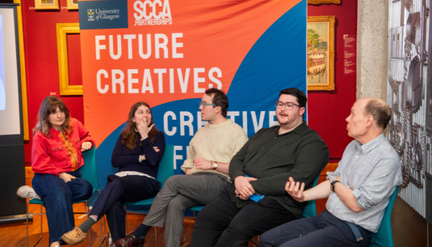 Five panelists sit in front of the 