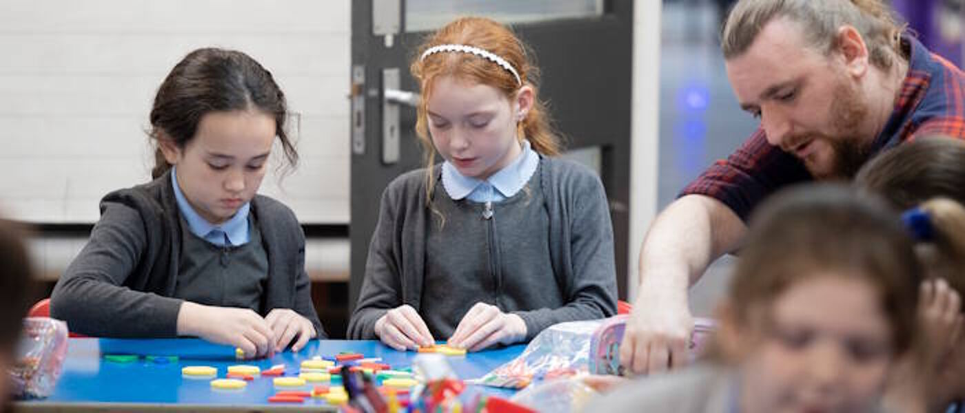 school children playing with lego