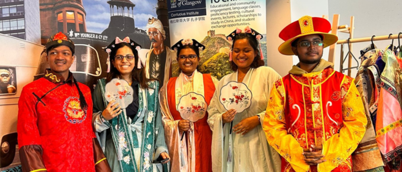 A group of students stand together dressed in traditional Chinese clothes