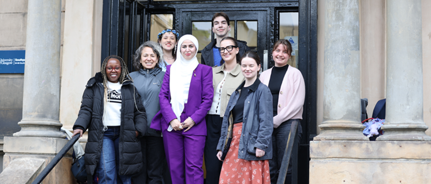 The GO Justice VOICES Ambassadors, gathered on the steps in front of a university building