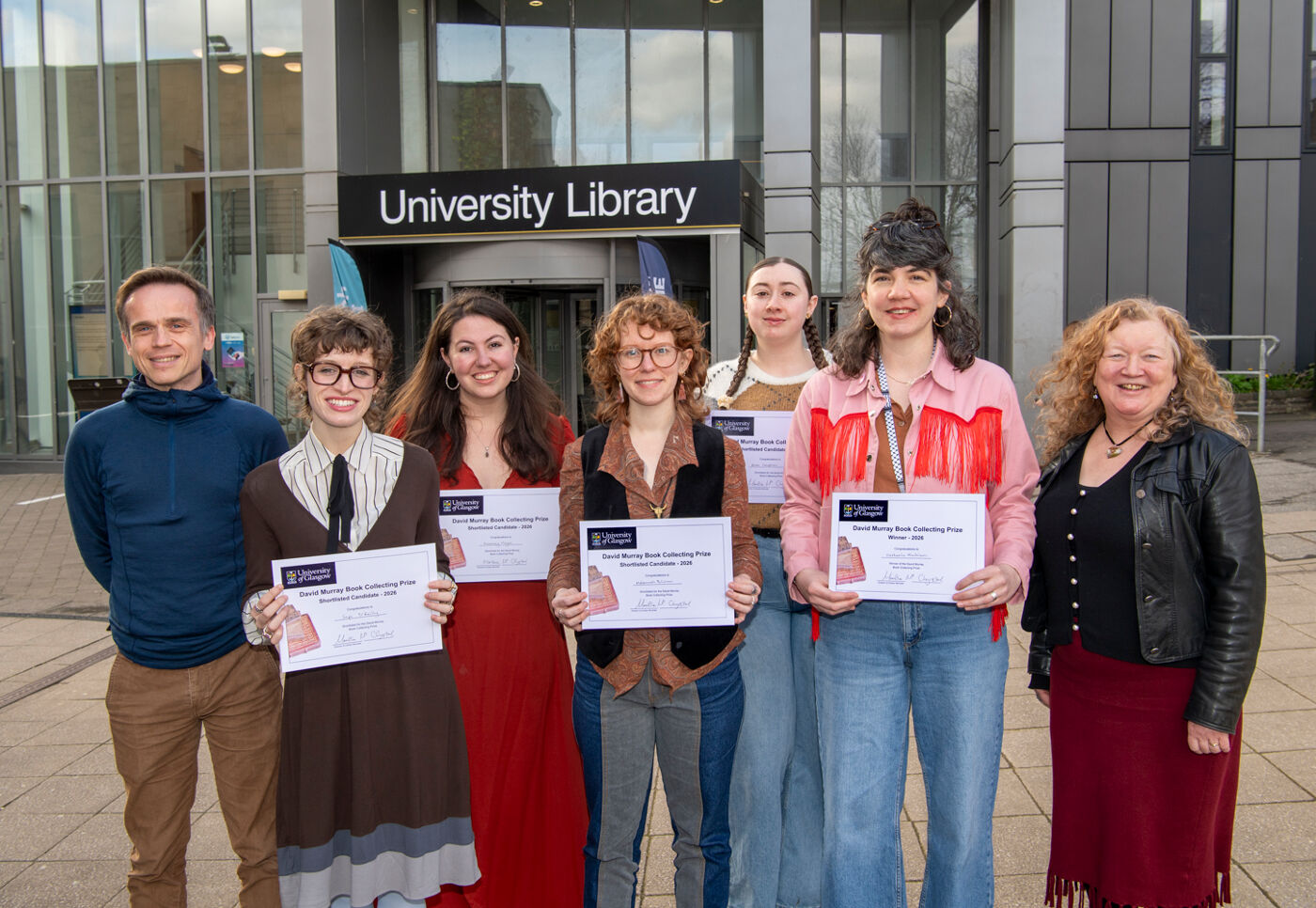 An image of the 5 shortlisted candidates and 2 judges for the 2026 David Murray Book Collecting Prize standing outside the University Library.