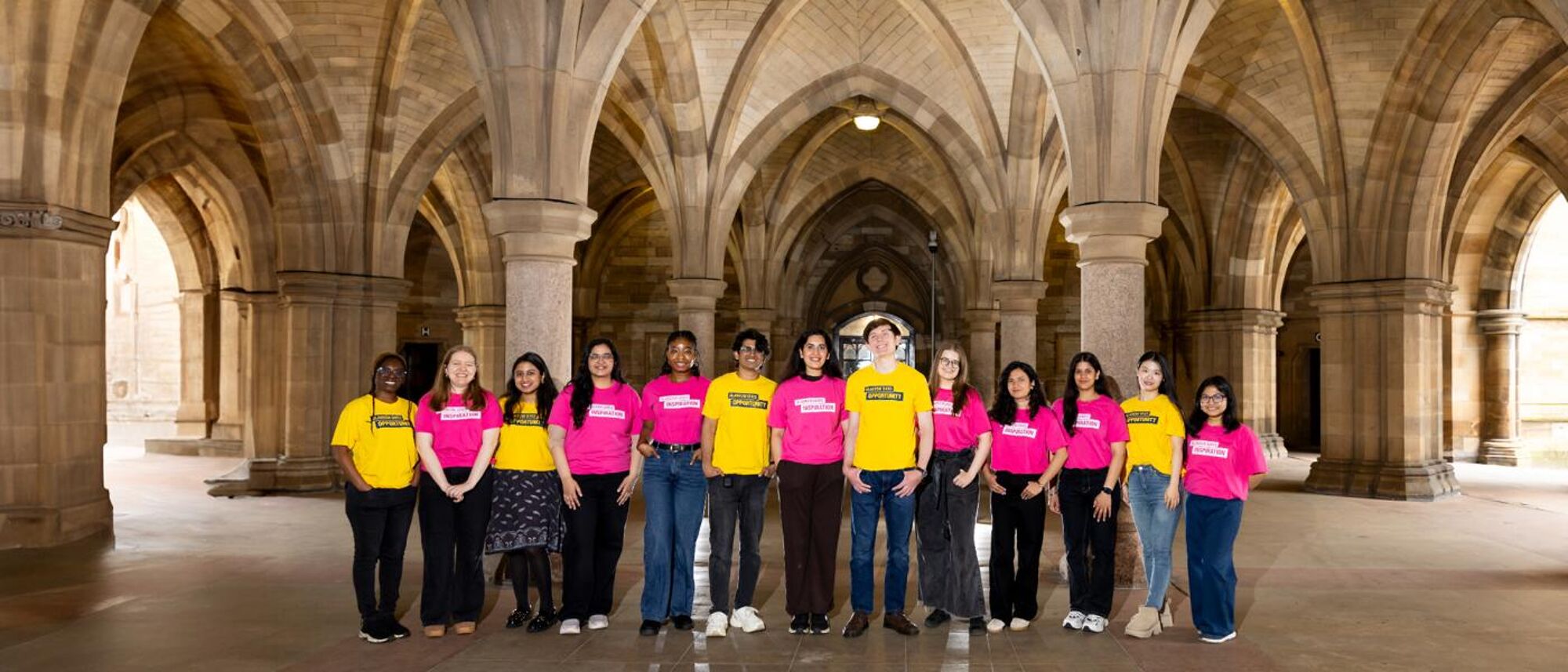 Students in yellow and pink t-shirts in the cloisters