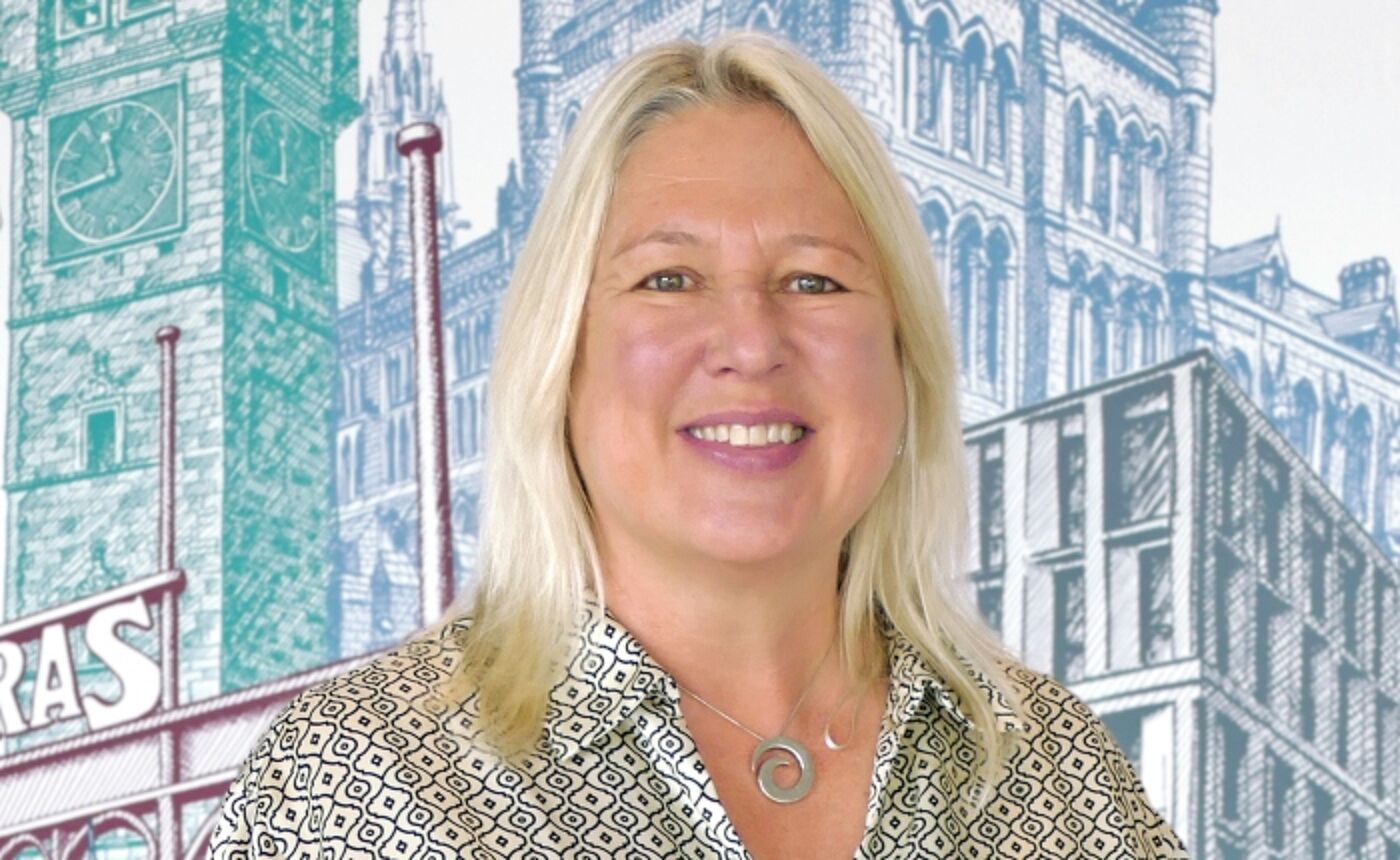Wendy Loretto profile photo in front of a wall mural at the Adam Smith Business School