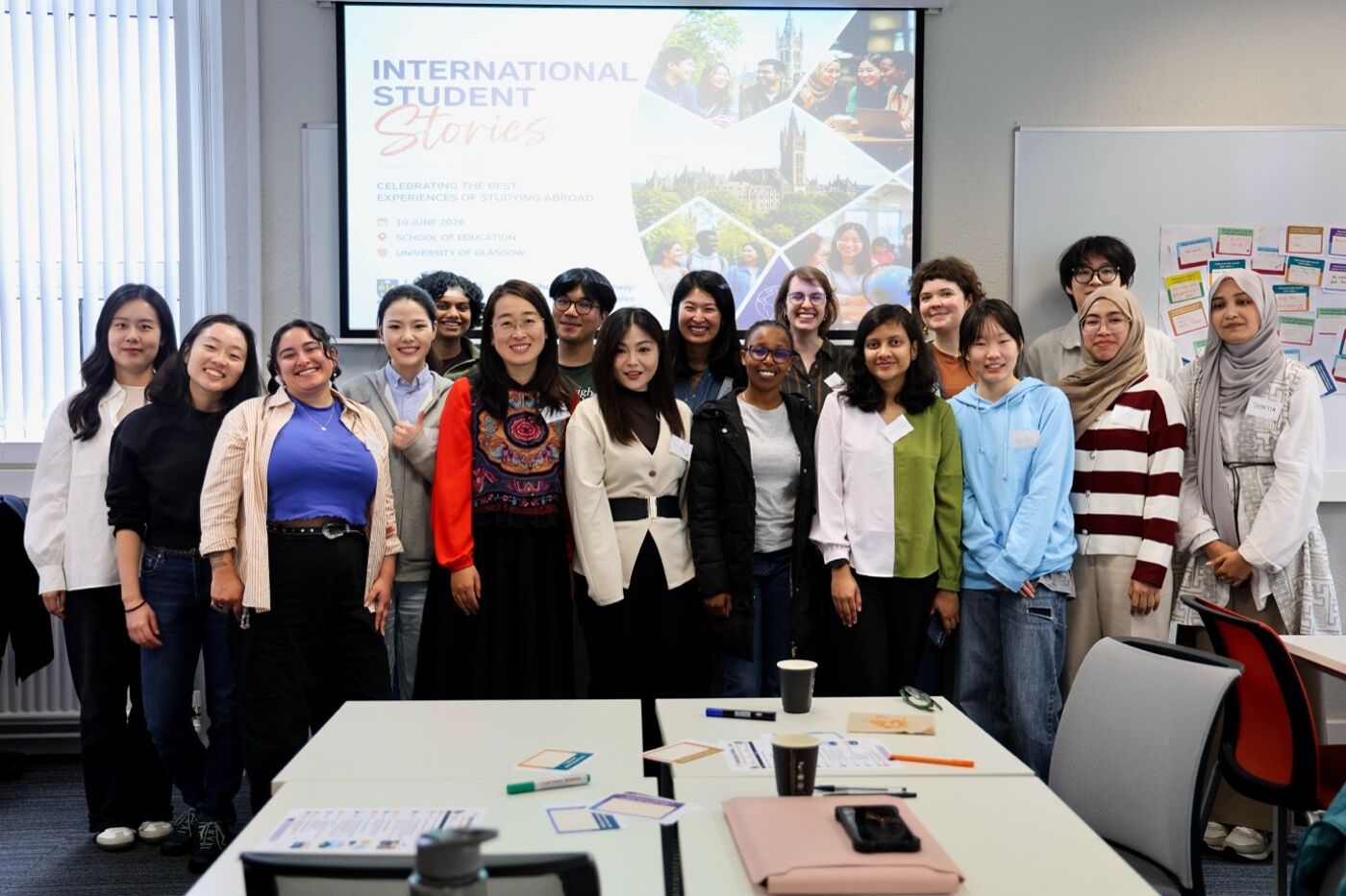 Group of staff and students standing in front of a lecture theatre