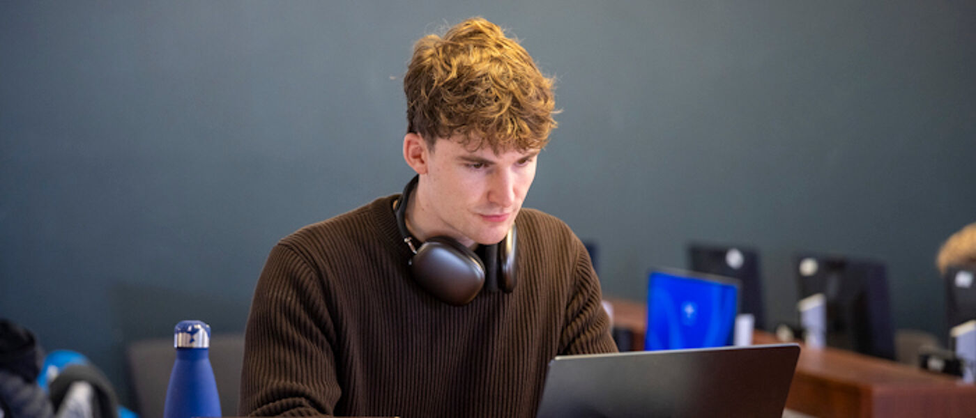 A student using a laptop to study in the Library