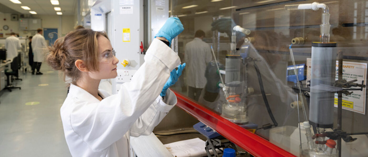 A chemistry student working with lab equipment