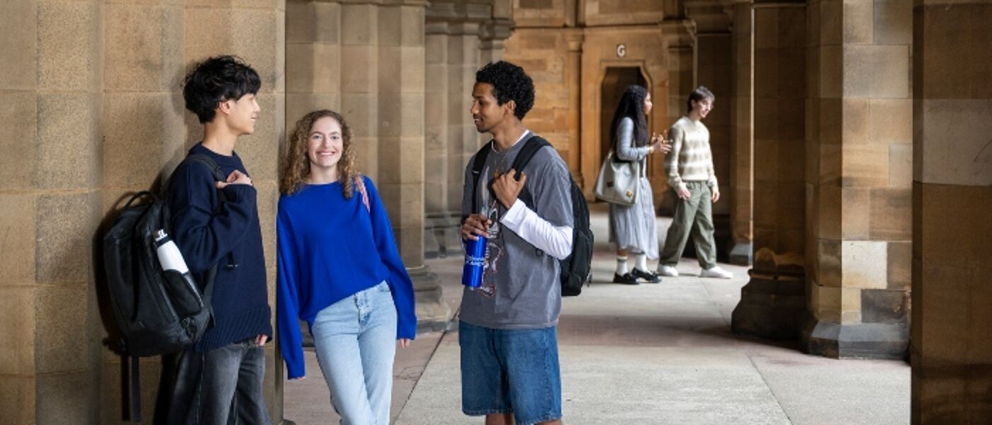 Students in the Cloisters of the Gilbert Scott Building