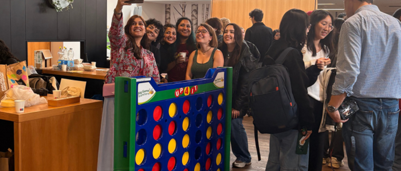 a large group of students chatting, taking photos and playing games