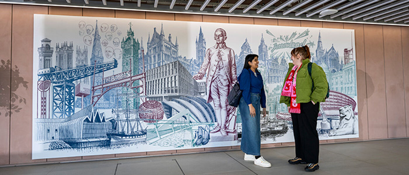 Students in front of mural in the Interior of the Adam Smith Building.
