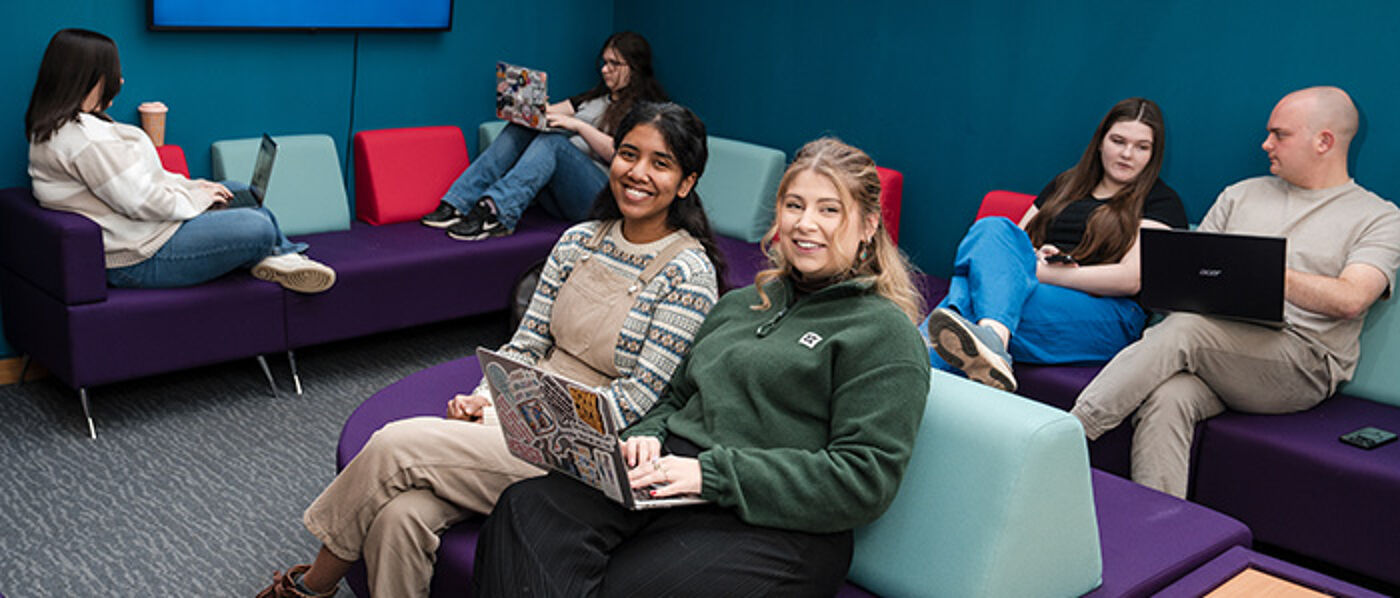 Students sitting in a social space at Dumfries Campus