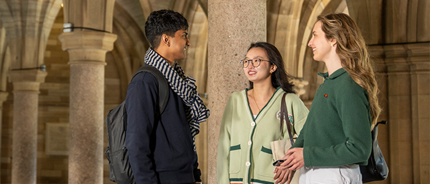 Students standing in cloisters chatting