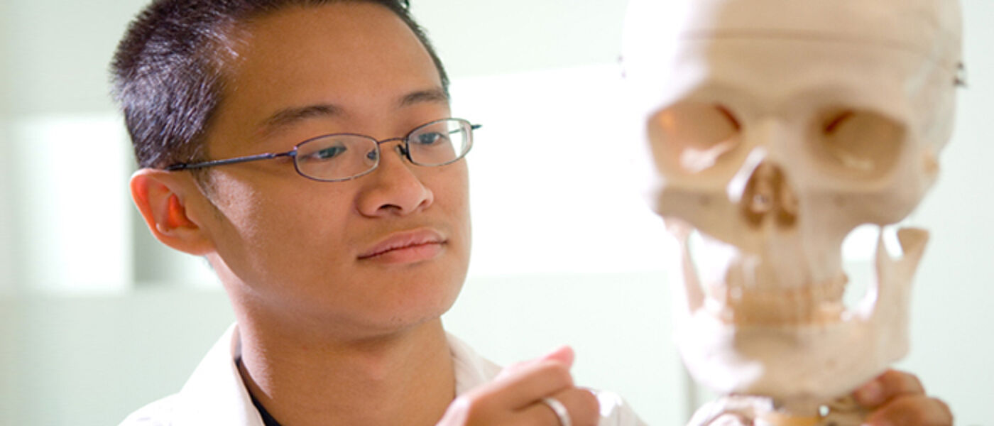 Image of Chinese male student with skeleton skull