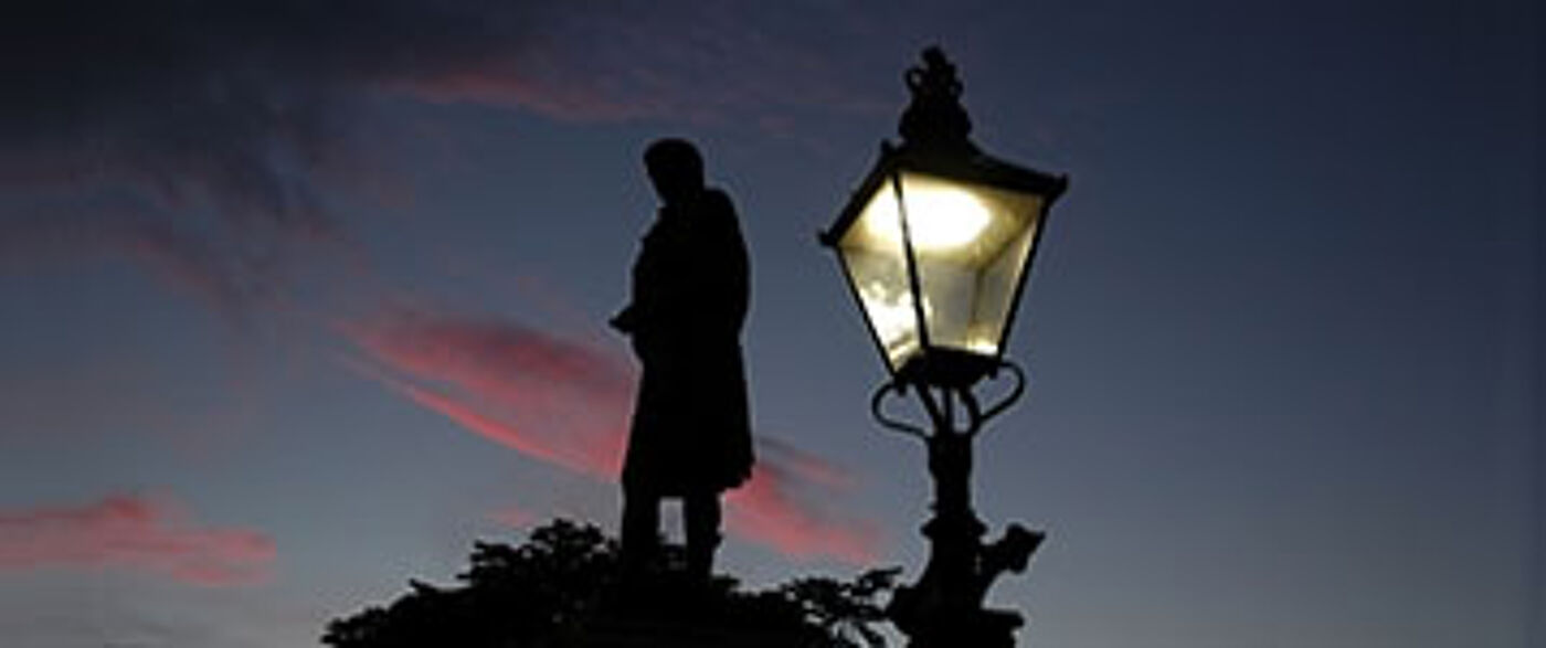 Robert Burns statue in Aberdeen at sunset