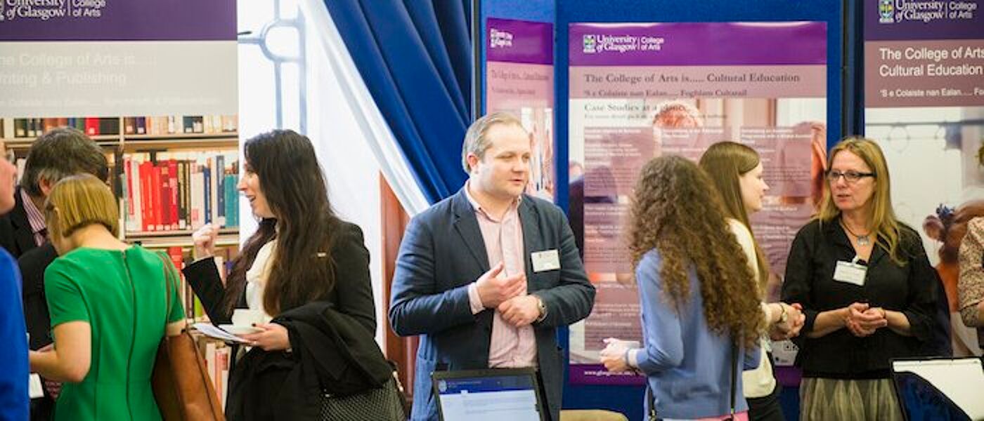 Photograph of a group of people talking at the College of Arts Industry Day