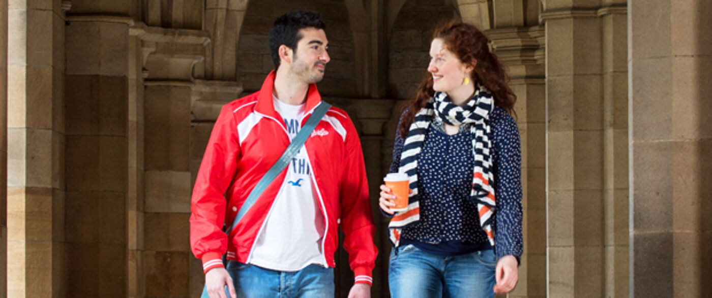 PGT Prospective students - 2 students in cloisters walking and talking