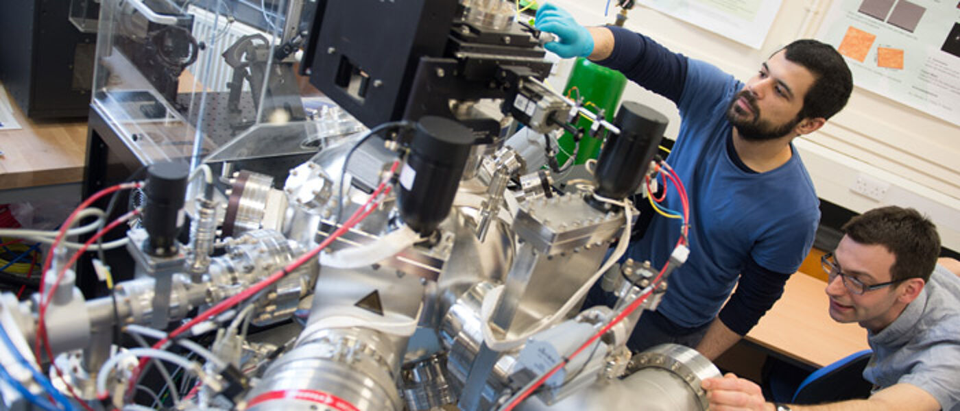 PLD vacuum chamber. Scientists setting up an experiment