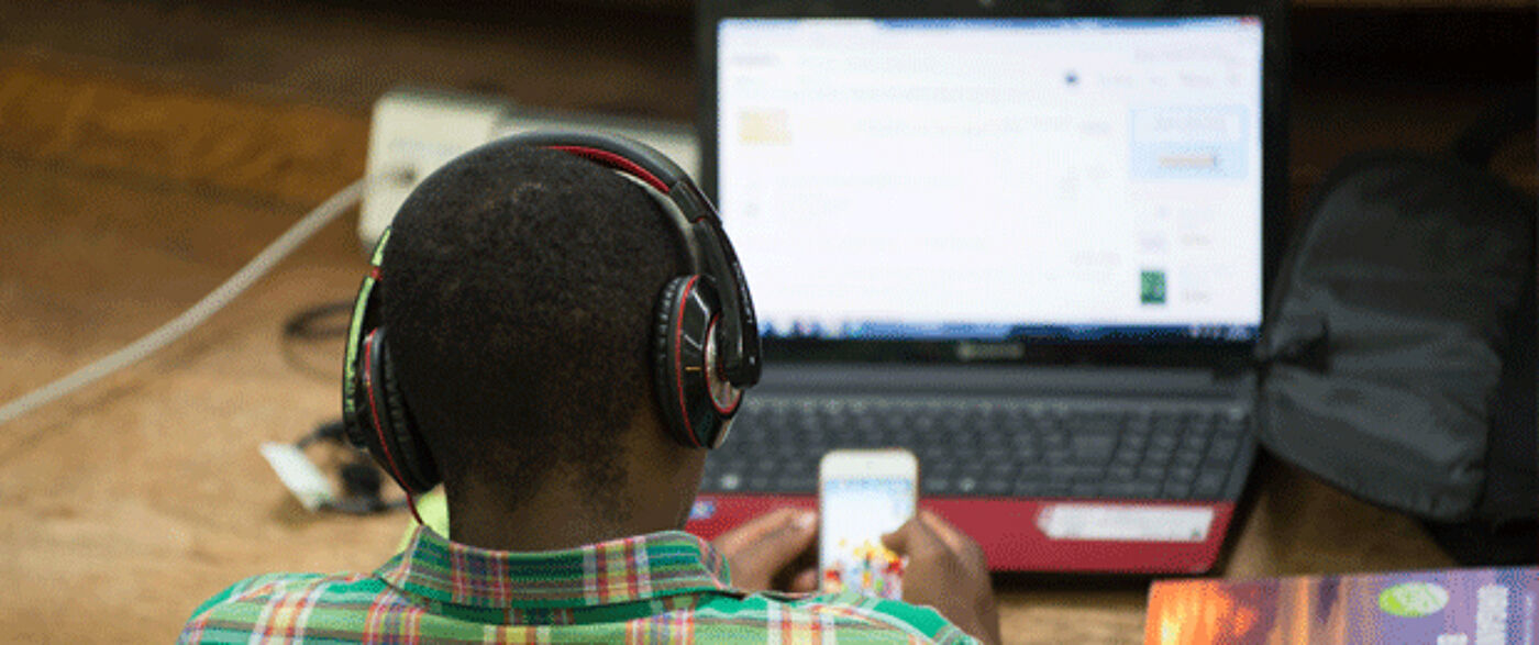 Student engaged with elearning via laptop and mobile phone