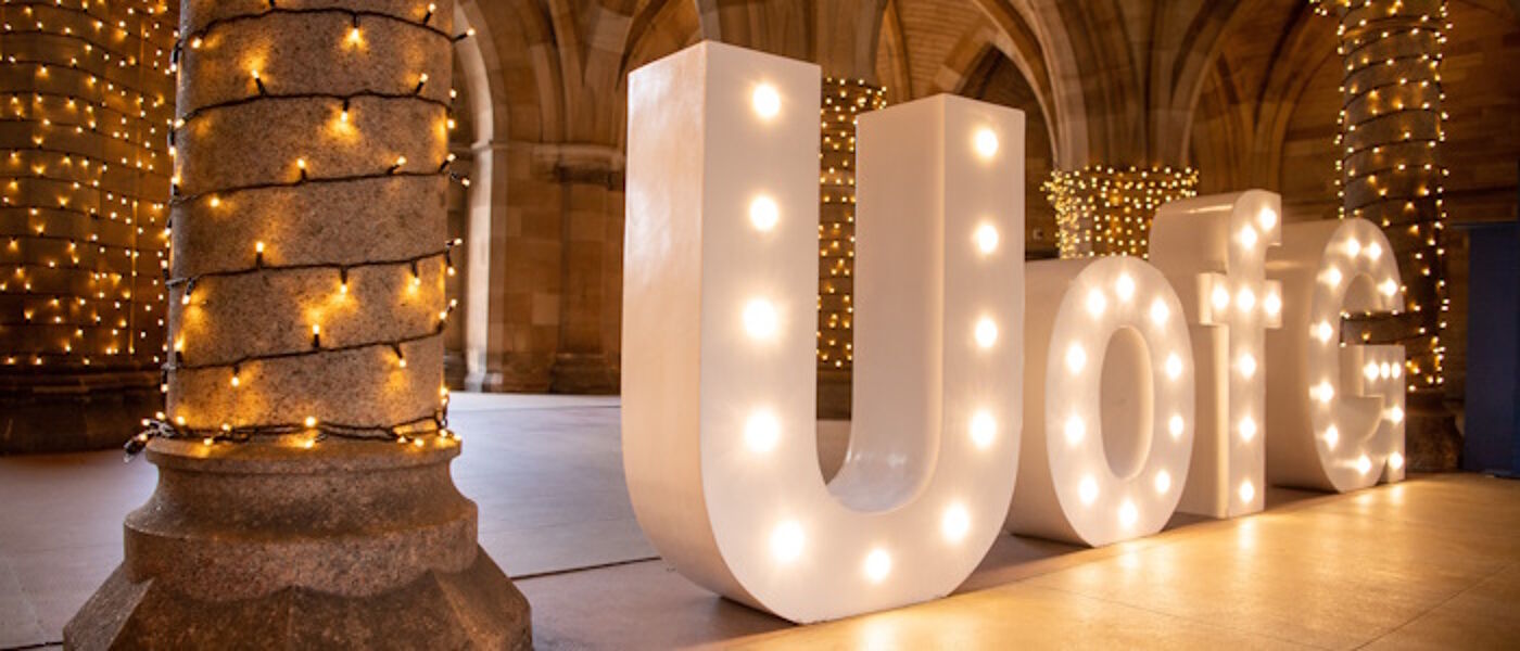 Undercroft graduation with UofG letters lit up