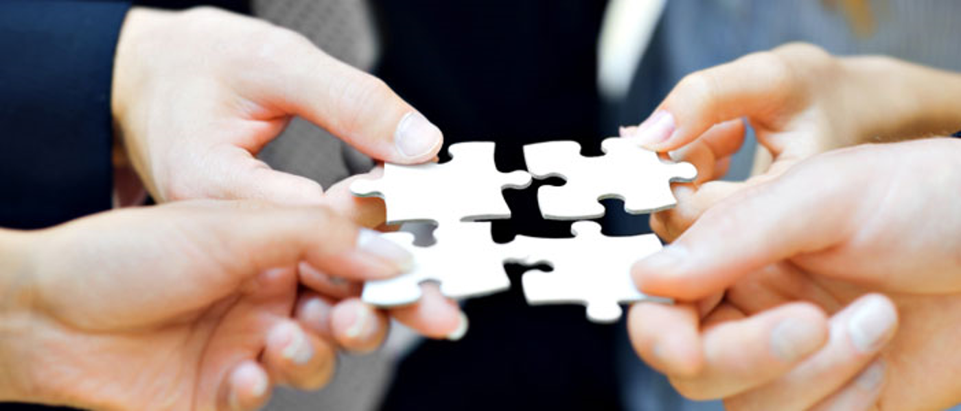 photo of people holding jigsaw pieces