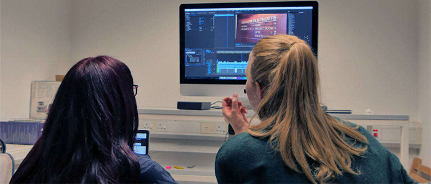 students editing at a computer