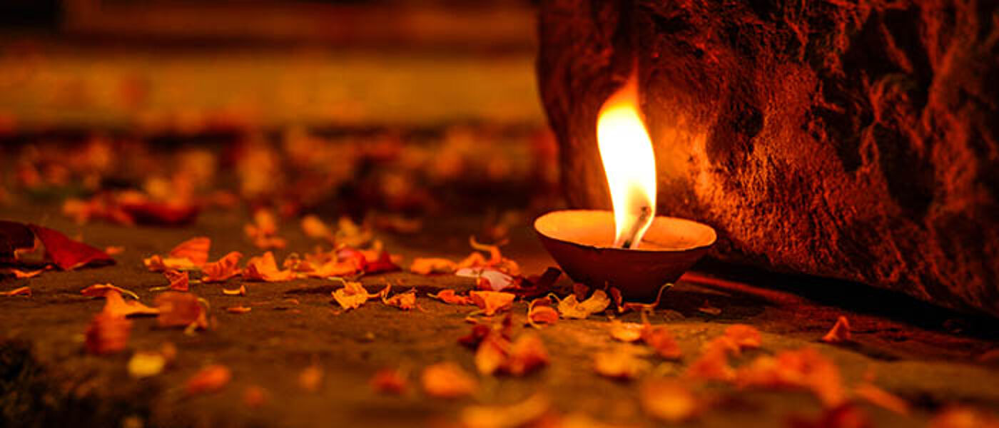 Candle surrounded by petals