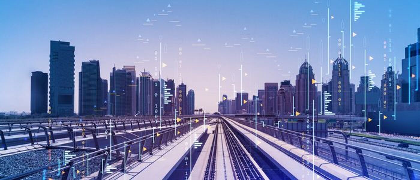 Image of modern train tracks in front of skyscrapers 