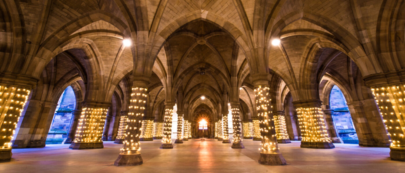 The cloisters with lights on the pillars