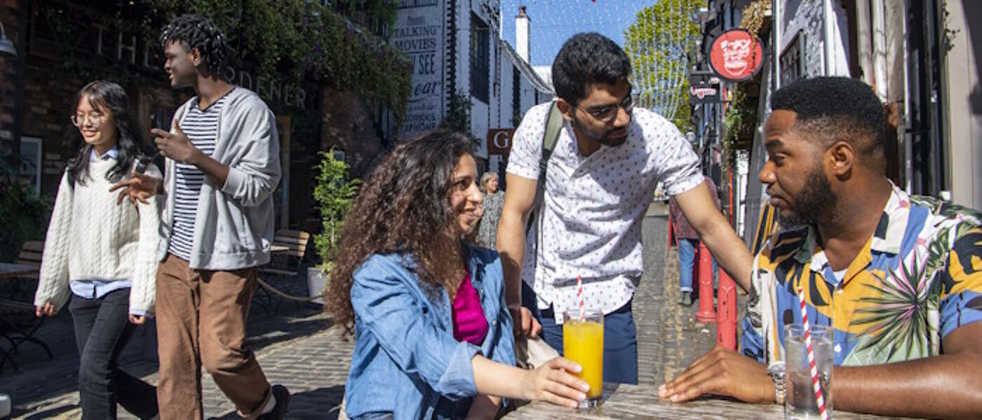 Students sitting outside on Ashton Lane
