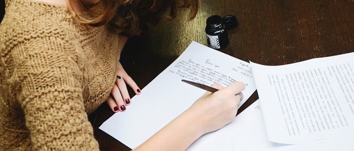 A girl writing at a table