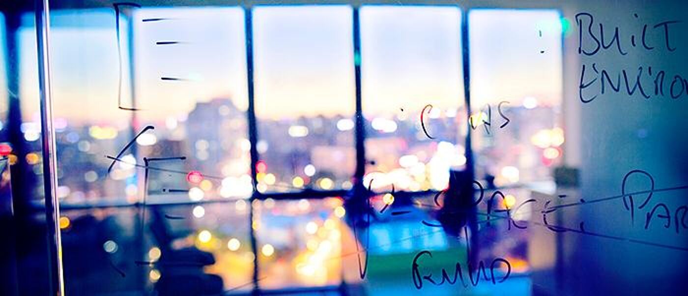 Sketch diagrams on glass wall in design planning office. 700 pixels