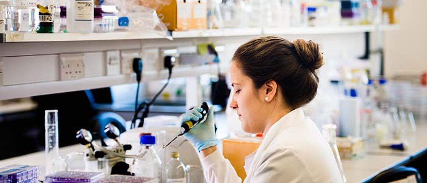 Image of female student working in a lab