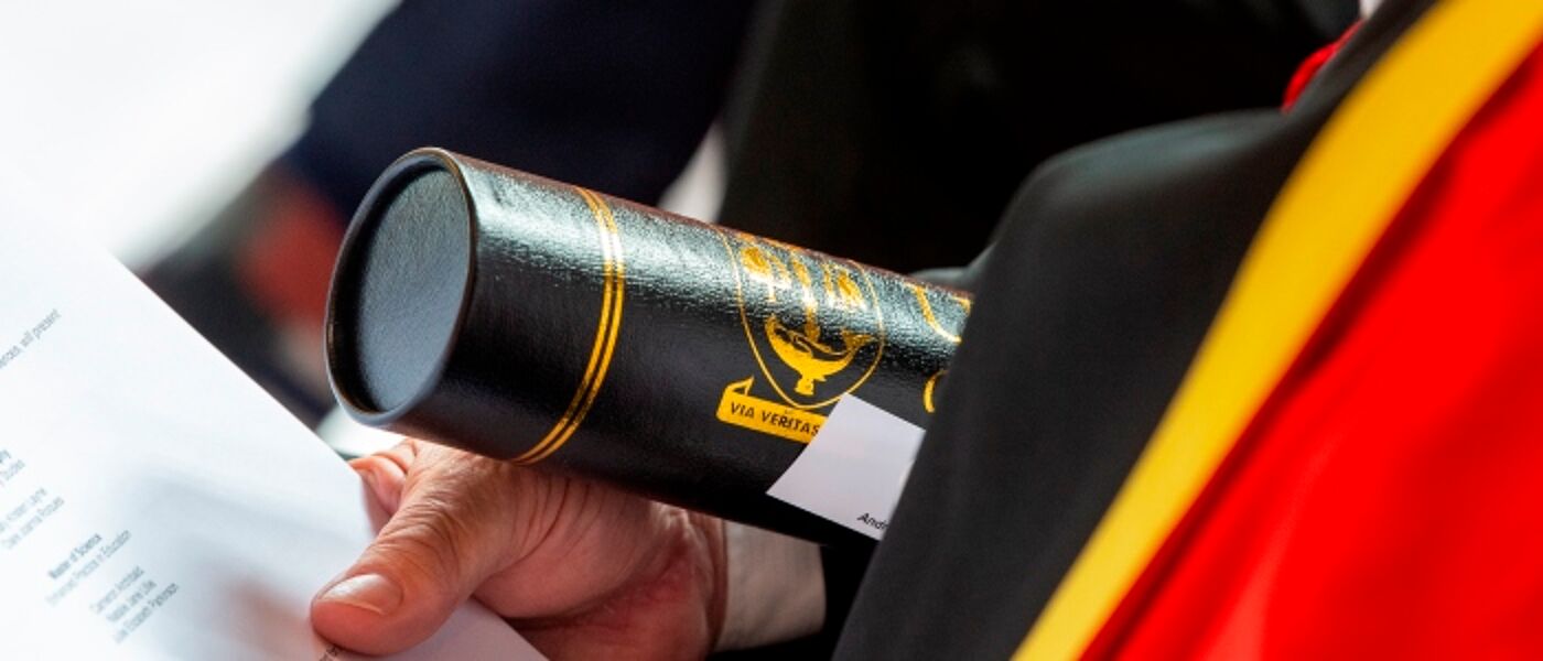 Graduation scroll in hand