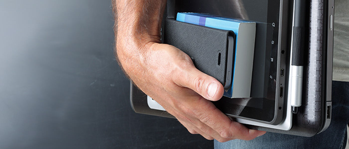 man's hand holding mobile devices