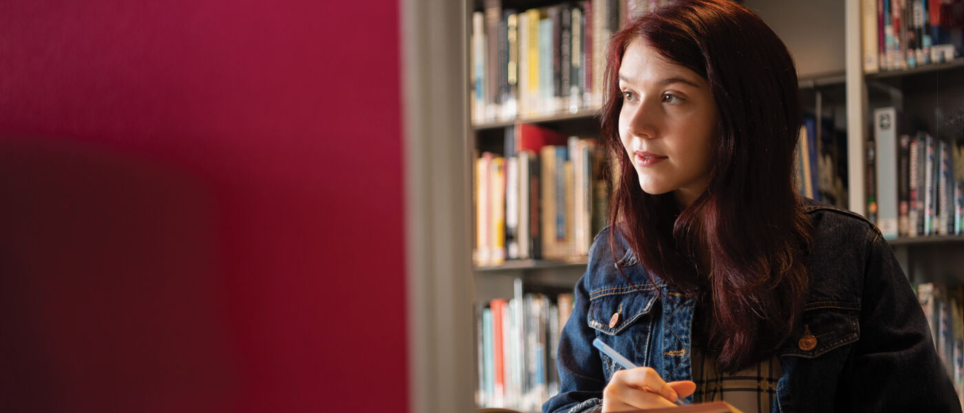 student on a computer in the library