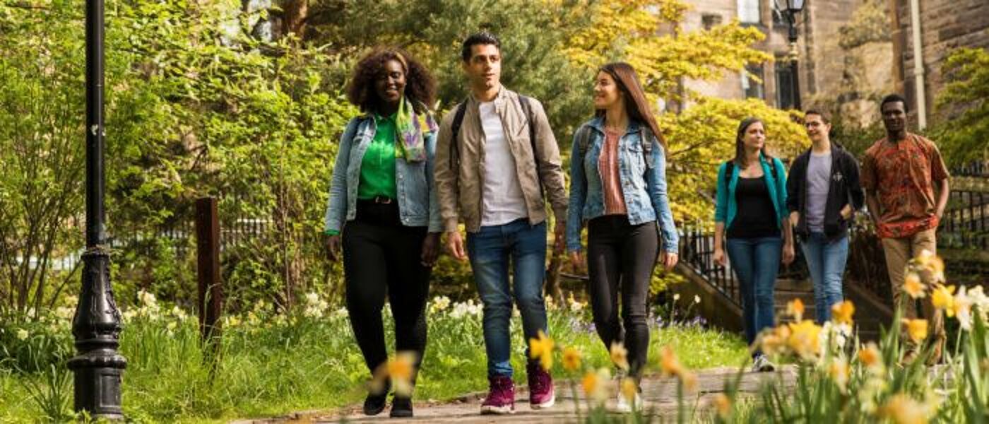 Group of students walking through the campus